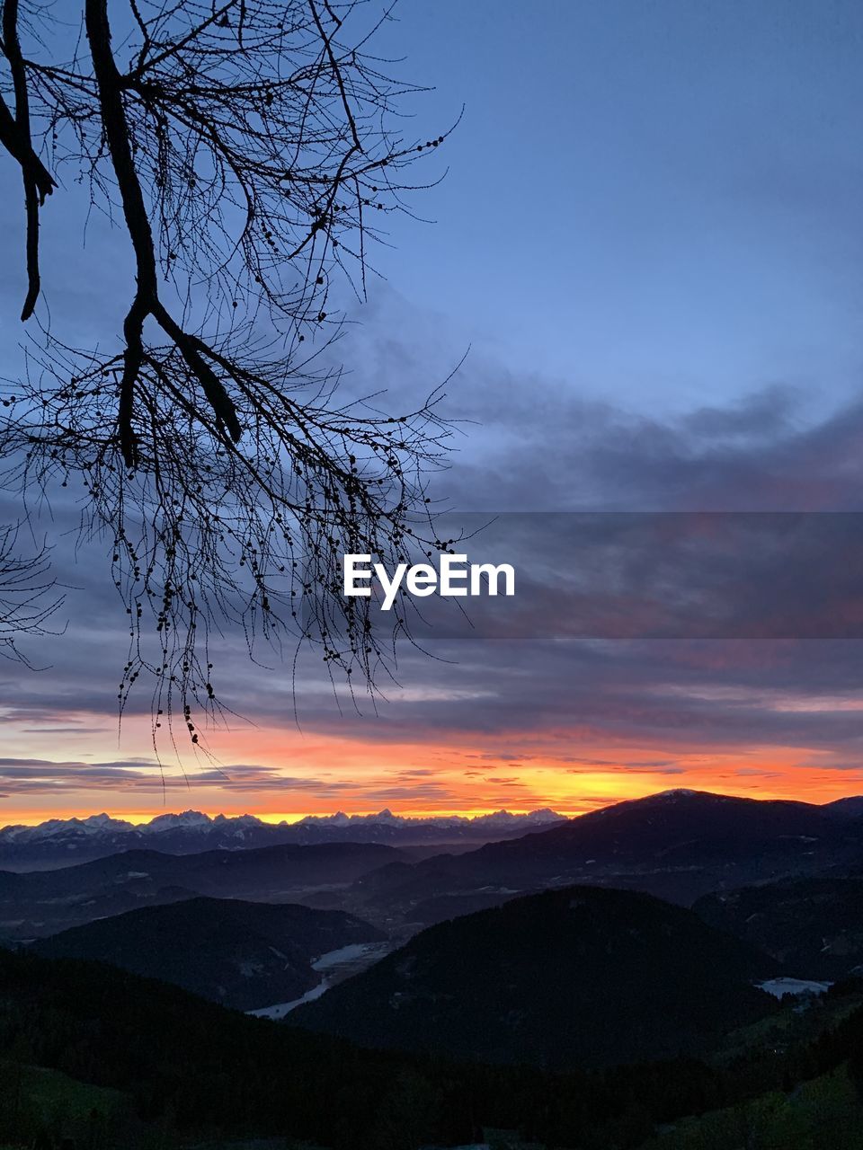 Scenic view of silhouette mountains against sky at sunset