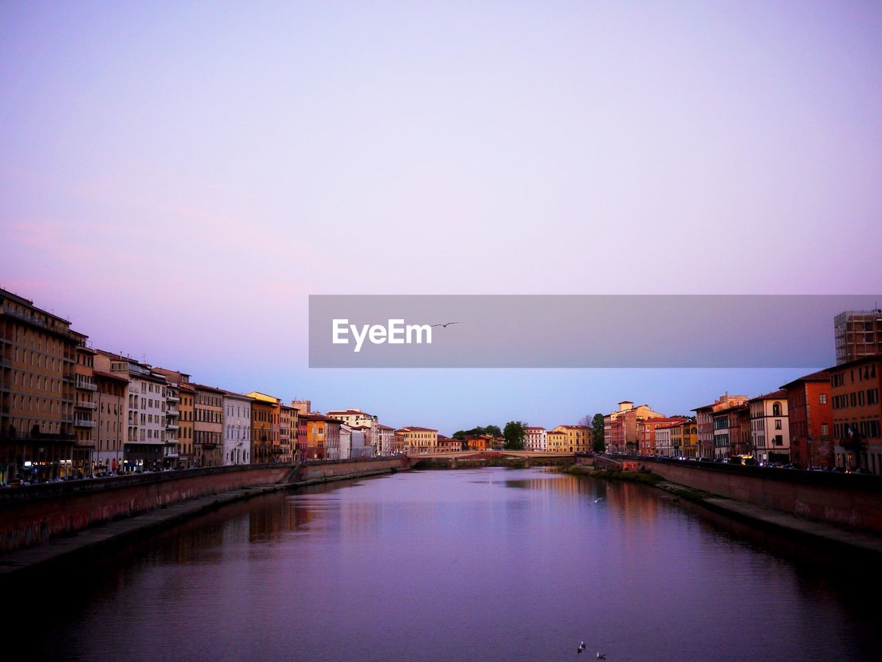 BRIDGE OVER RIVER AGAINST SKY IN CITY