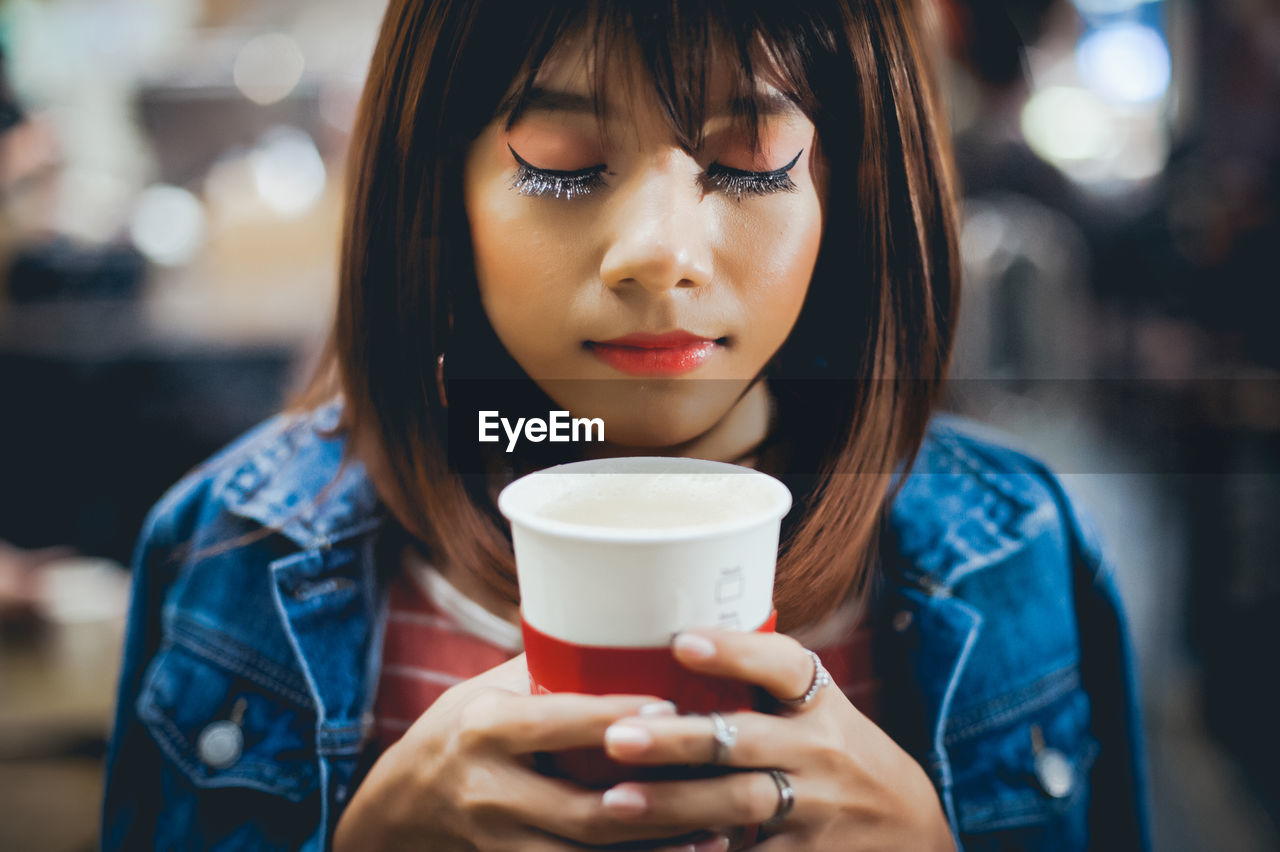 Close-up of woman drinking coffee