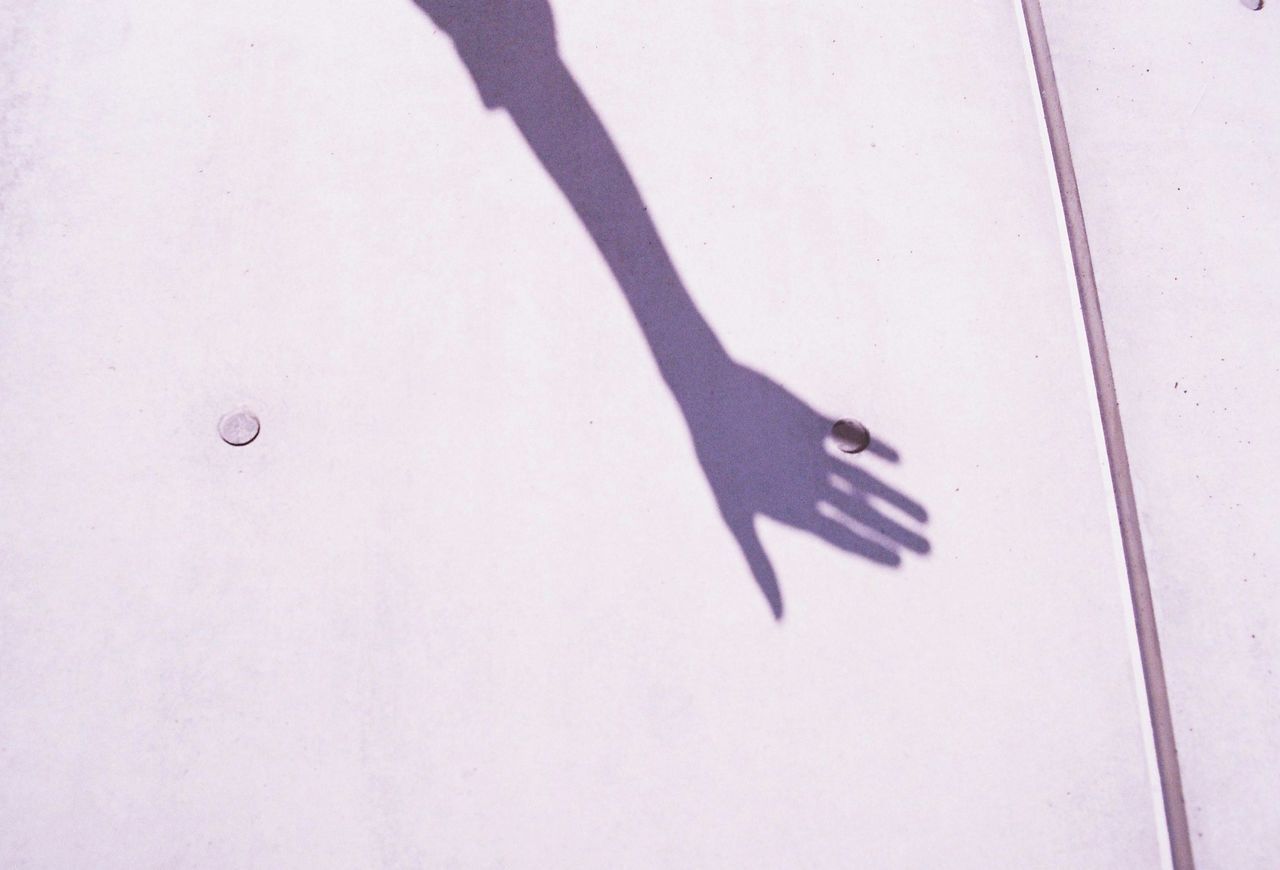 Shadow of human hand on wall