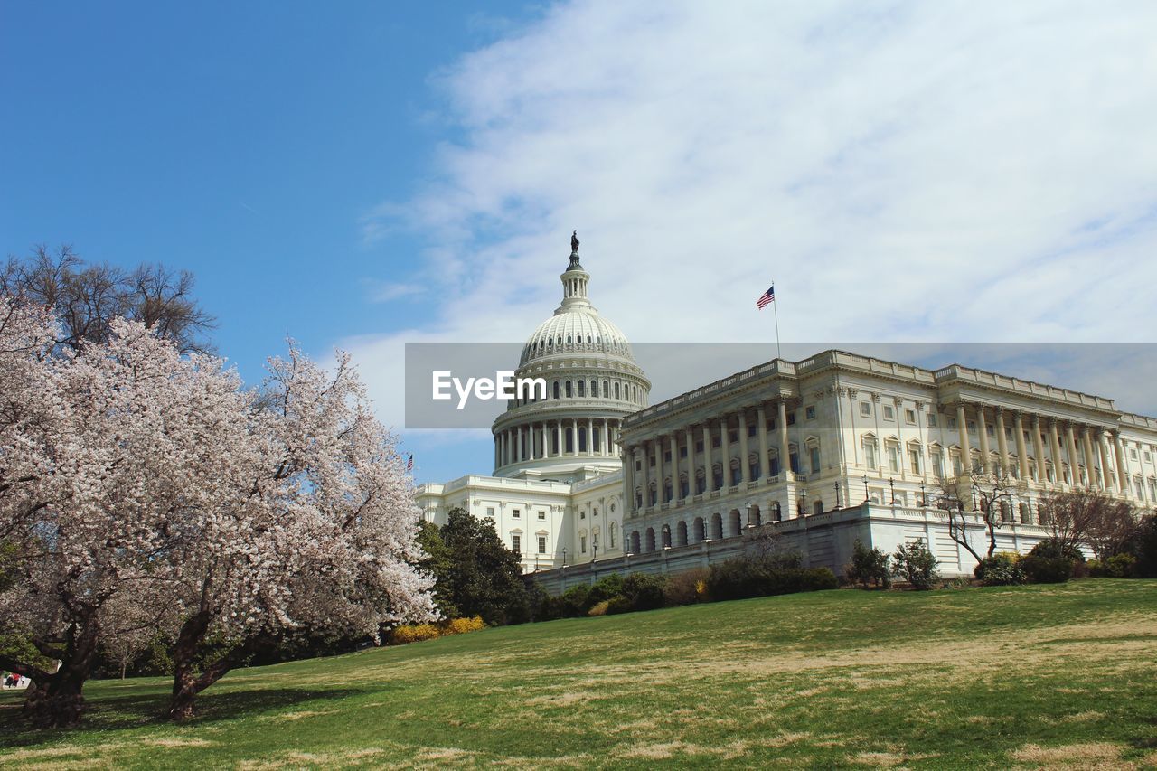 Low angle view of state capitol building against sky during sunny day