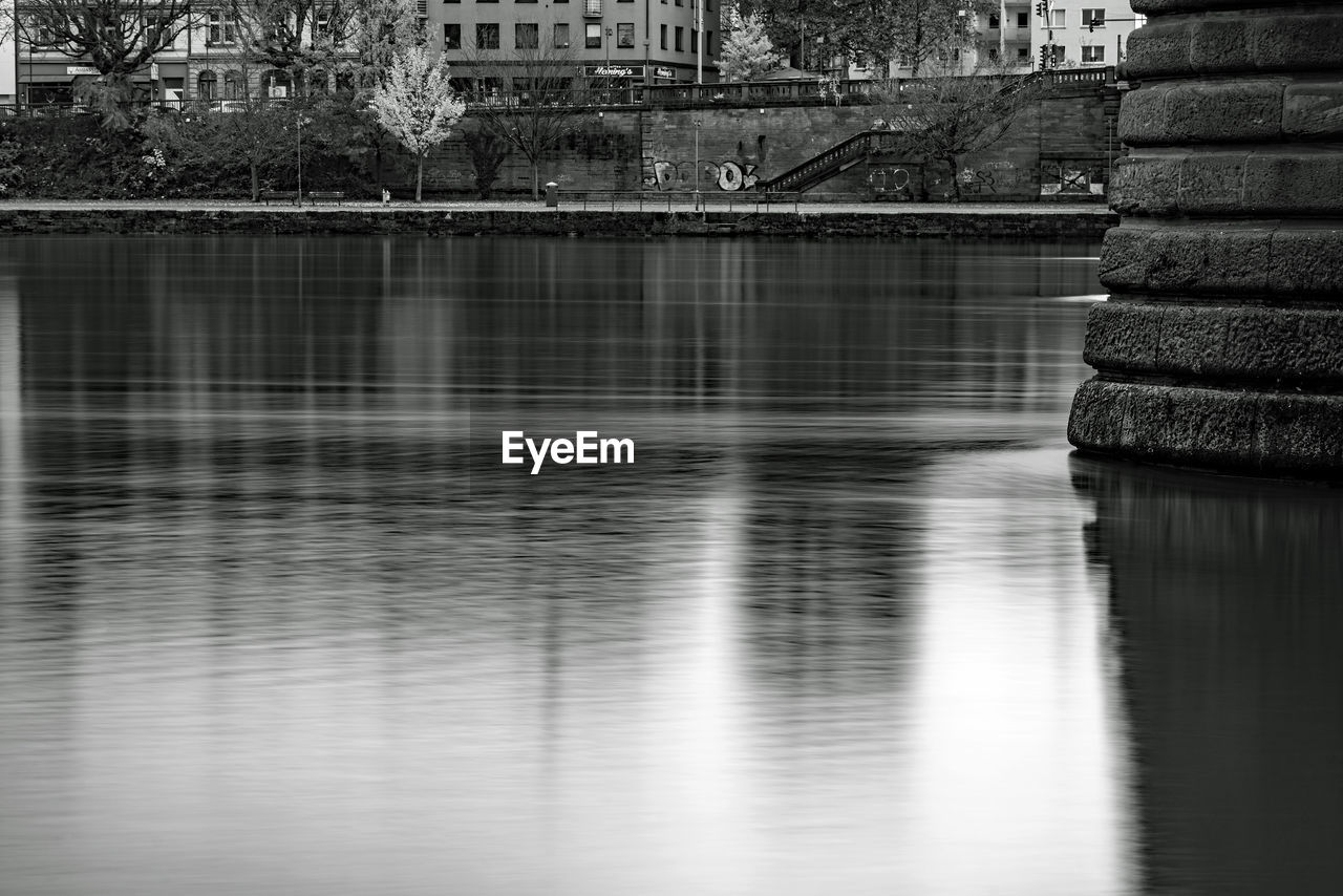 reflection, water, black and white, architecture, built structure, monochrome photography, monochrome, waterfront, black, building exterior, no people, nature, tree, river, day, darkness, city, outdoors, building, white