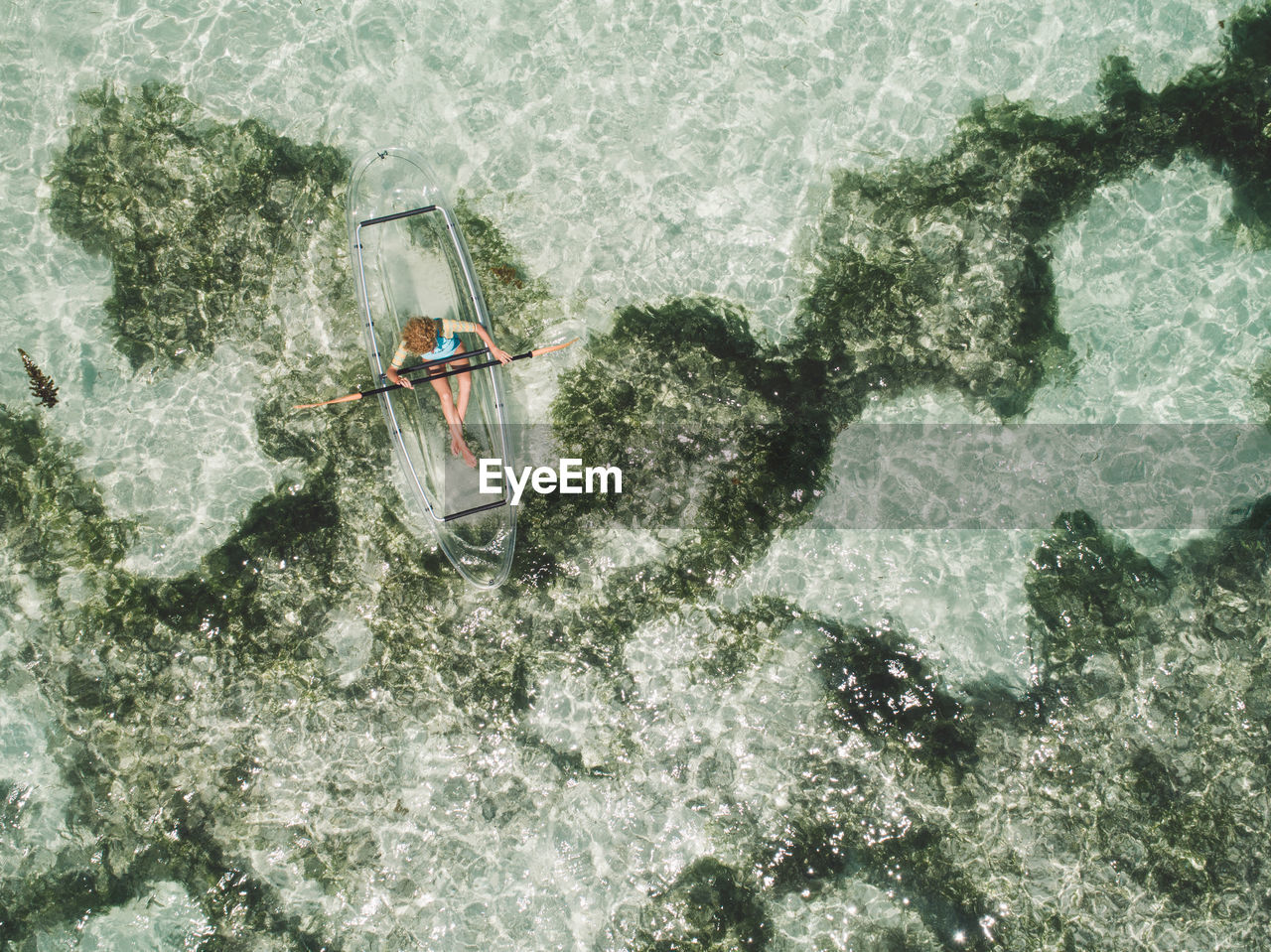 Directly above shot of woman on inflatable boat in sea