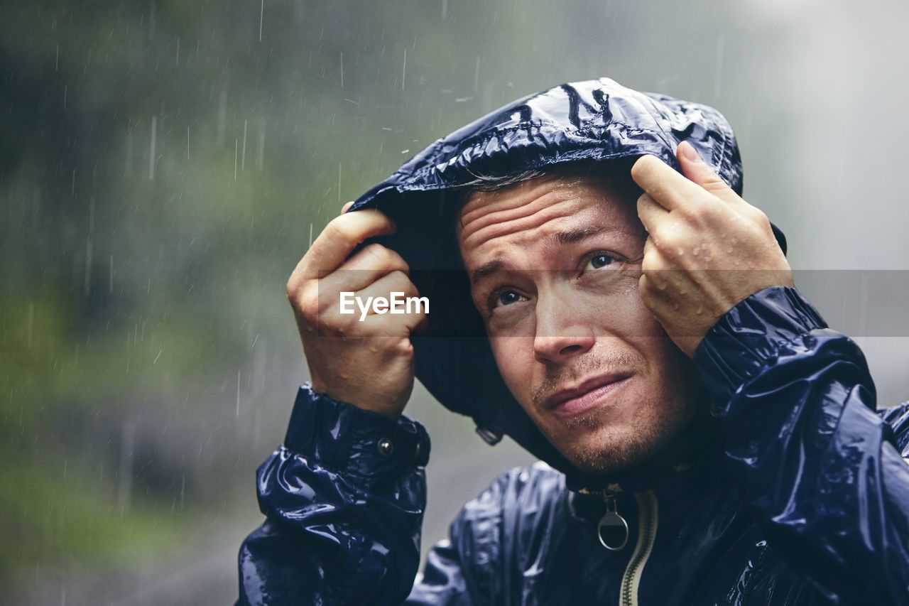 Man wearing raincoat during rainy season