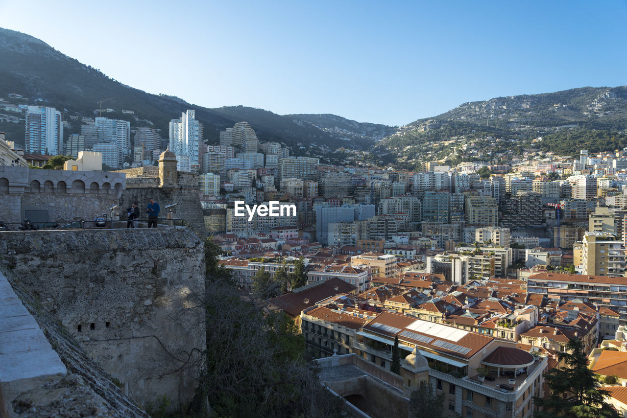 High angle view of city buildings against clear sky