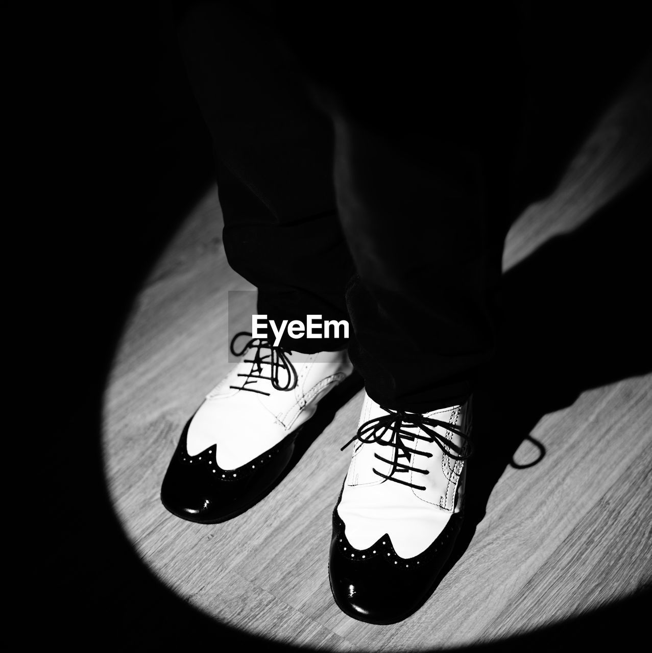 black, white, shoe, low section, black and white, footwear, human leg, one person, monochrome photography, monochrome, limb, human limb, lifestyles, adult, shadow, indoors, sneakers, darkness, standing, men, clothing, human foot, walking shoe, leisure activity