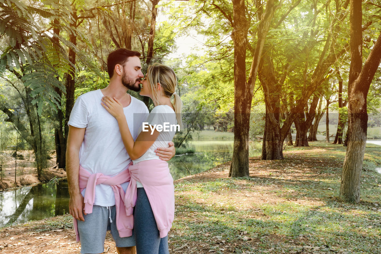 Romantic young couple standing at park