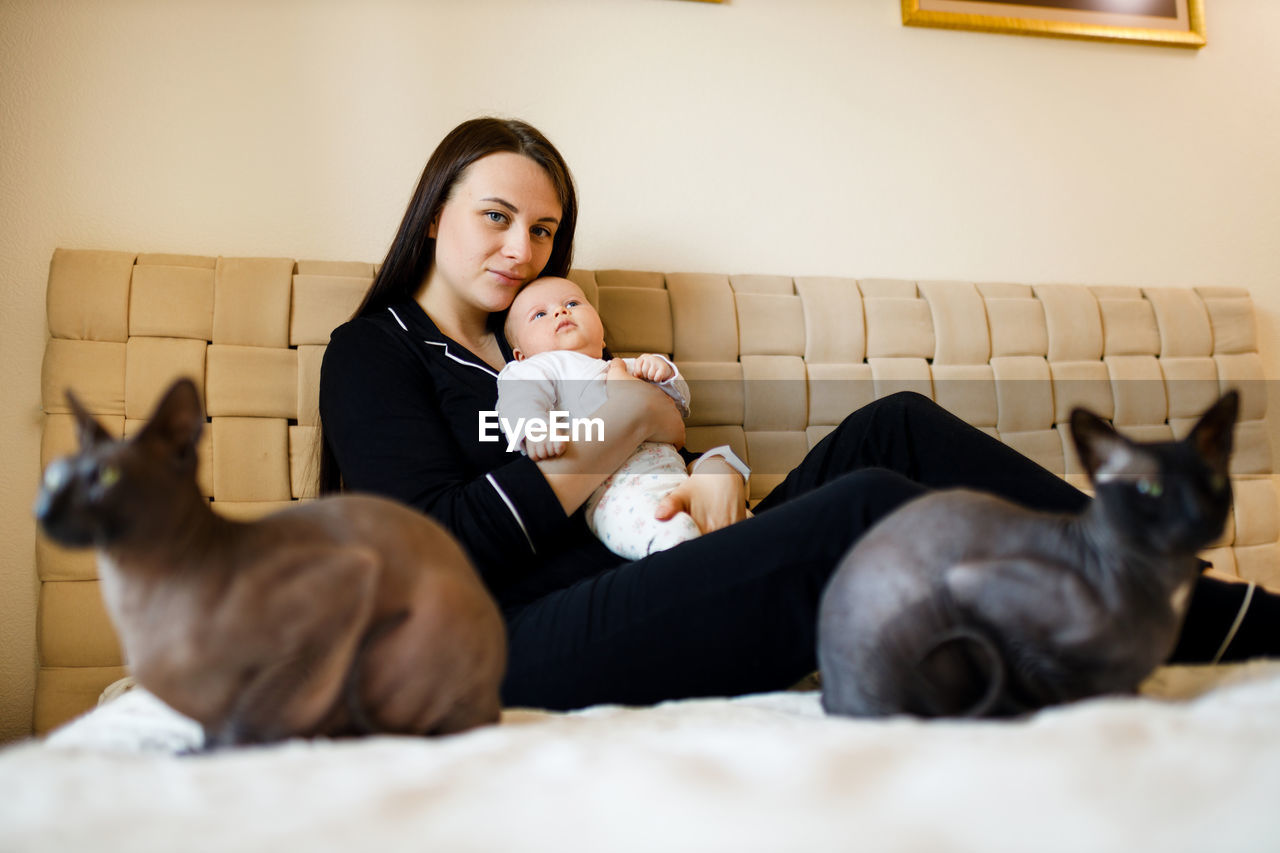 Portrait of young woman with baby