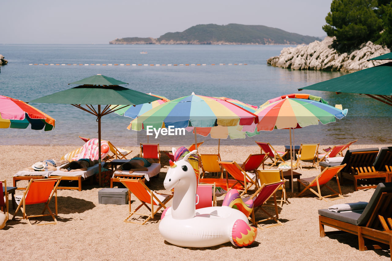 LOUNGE CHAIRS AND PARASOLS ON BEACH