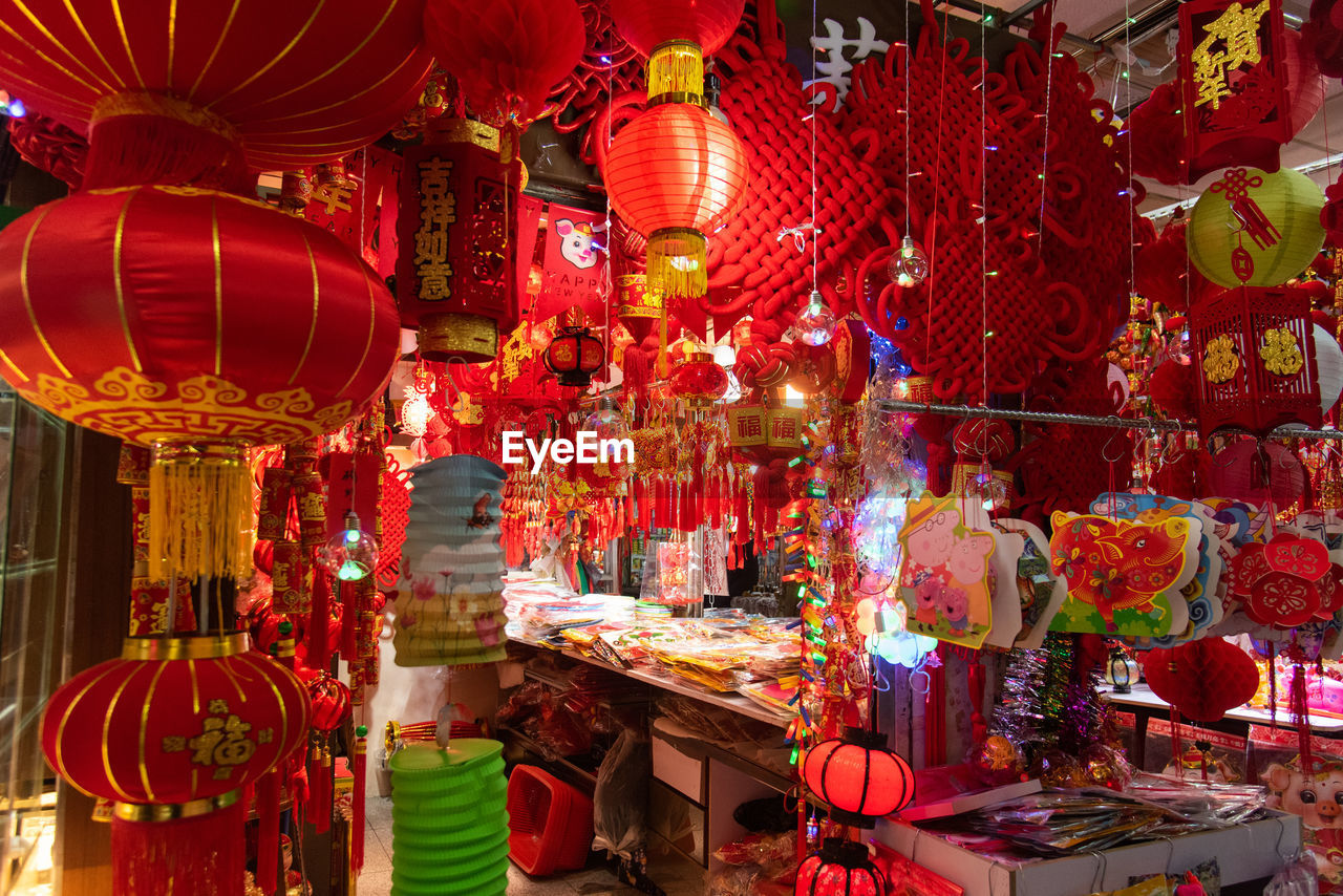 ILLUMINATED LANTERNS HANGING IN MARKET FOR SALE AT STREET