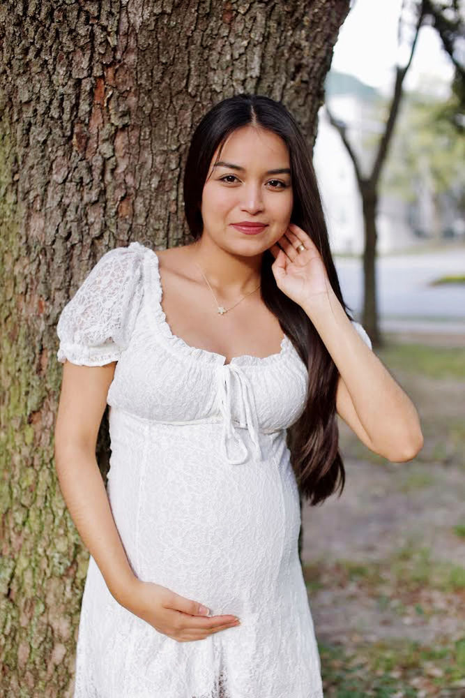 women, one person, adult, young adult, portrait, tree, tree trunk, long hair, plant, hairstyle, looking at camera, standing, trunk, dress, female, wedding dress, fashion, smiling, nature, clothing, happiness, emotion, white, portrait photography, front view, outdoors, three quarter length, photo shoot, brown hair, waist up, bride, day, lifestyles, bridal clothing, gown, person, looking, focus on foreground, black hair, casual clothing, leisure activity, positive emotion