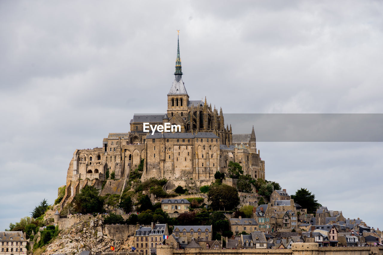 Low angle view of old building against cloudy sky