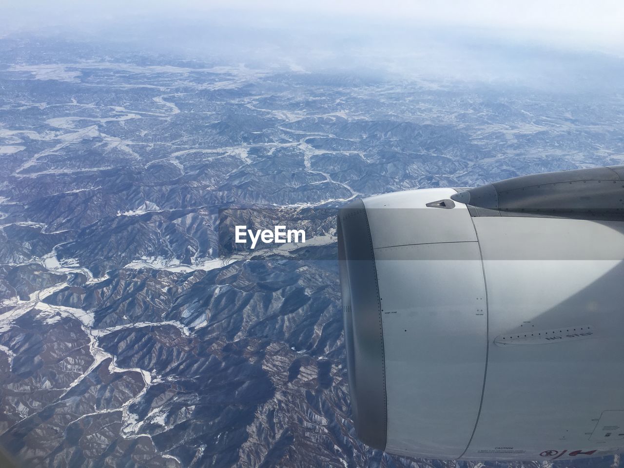 Cropped jet engine above mountains