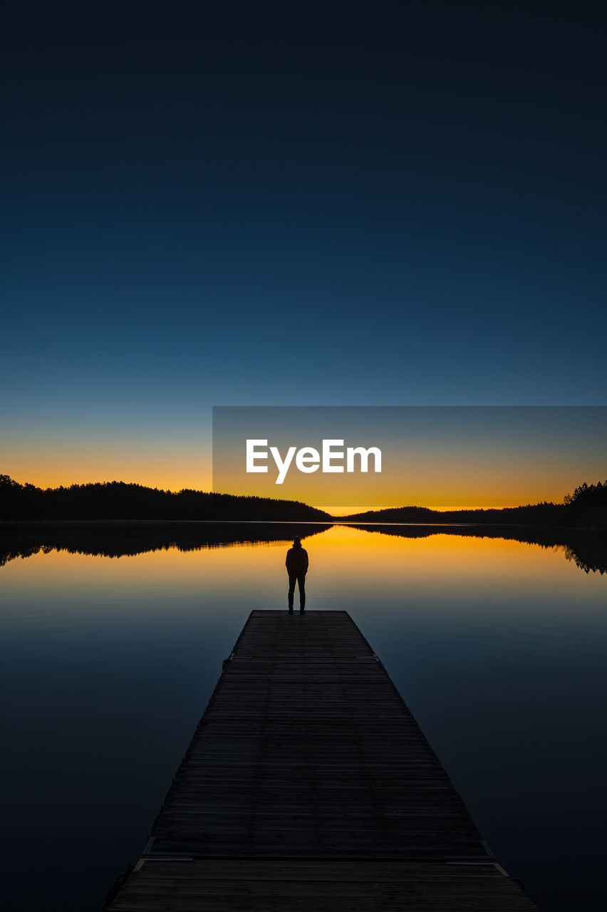 Silhouette of person on jetty