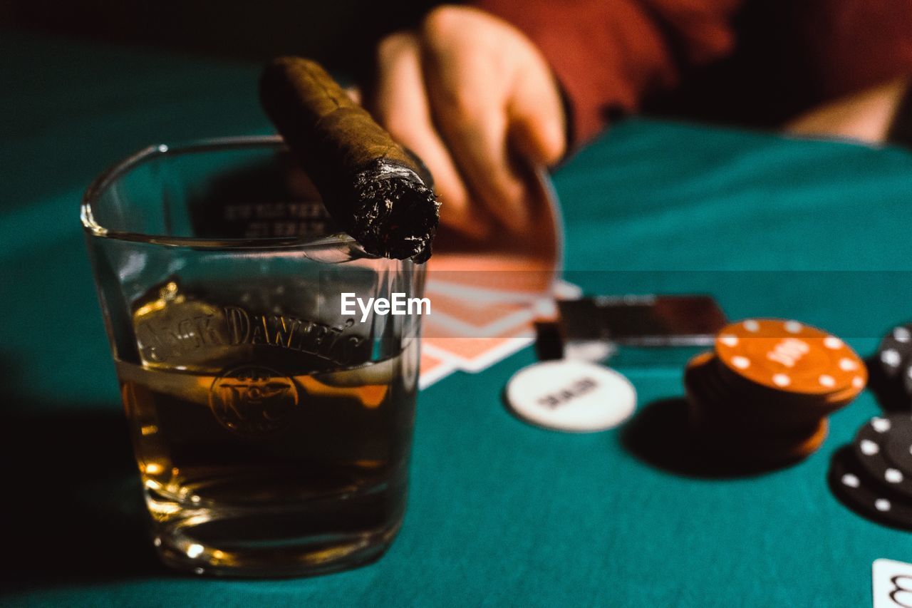 Close-up of alcohol with cigar on table