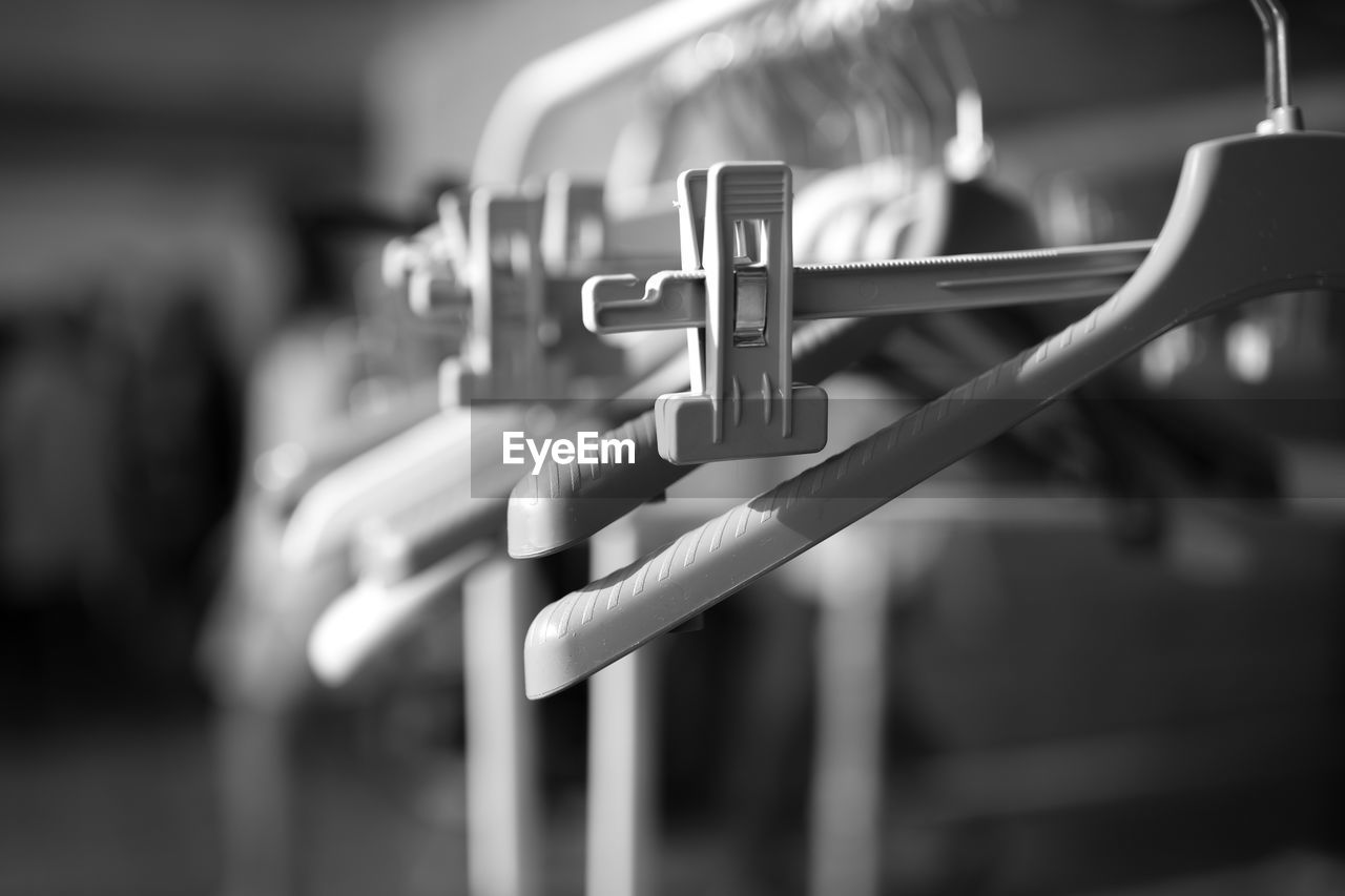 Close-up of coathangers hanging on rack at backstage