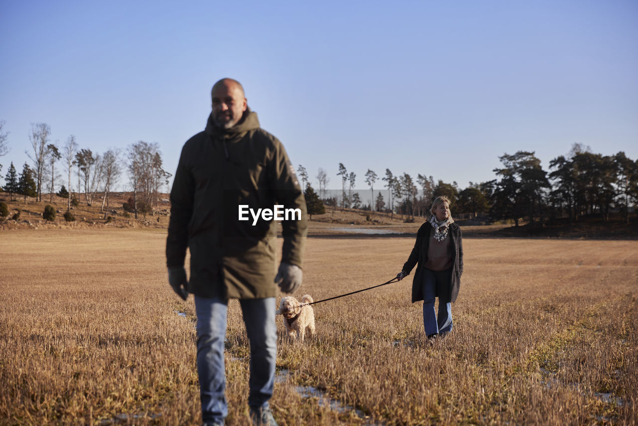 Couple walking with dog