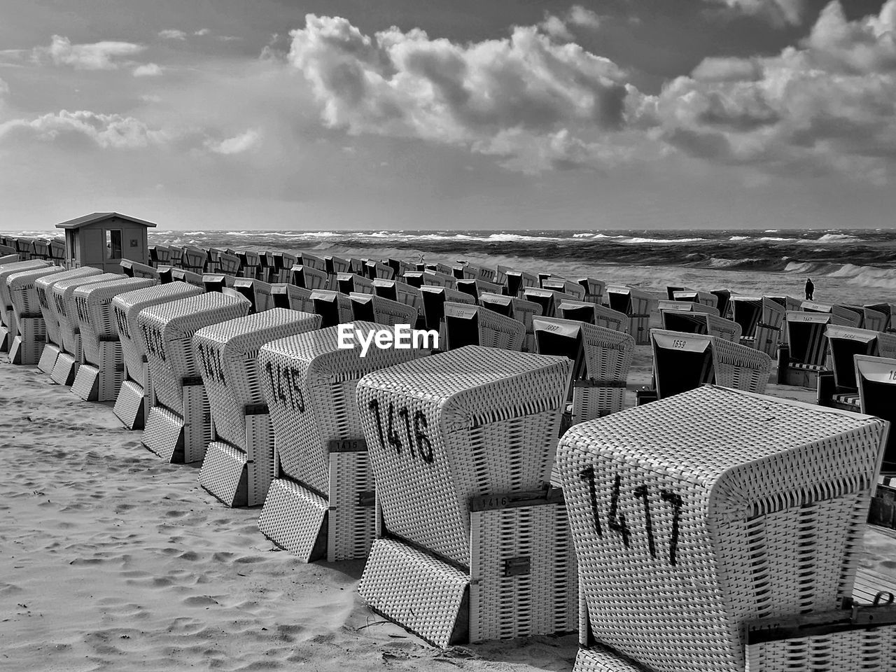 Beach chairs in a row in westerland / sylt in black and white against sky