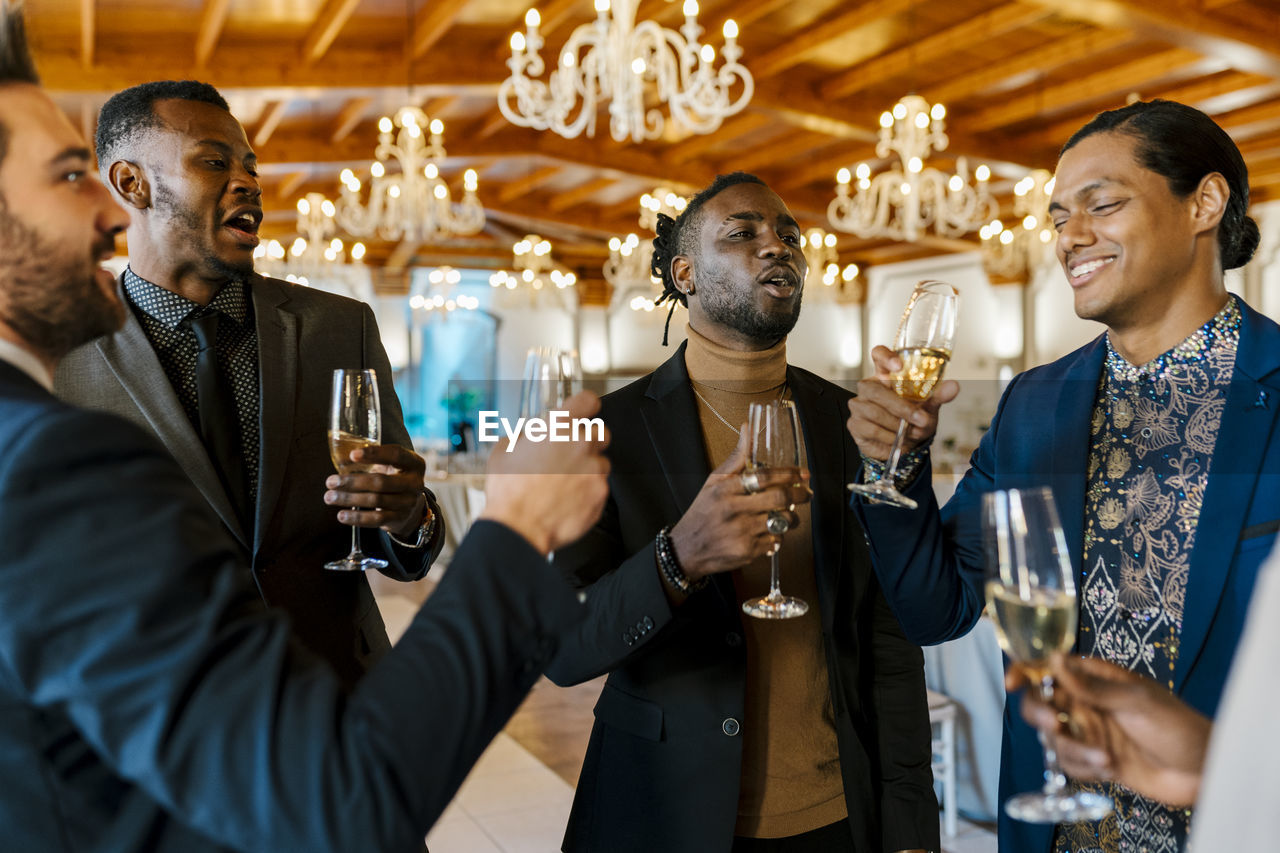 Male friends talking and enjoying at banquet