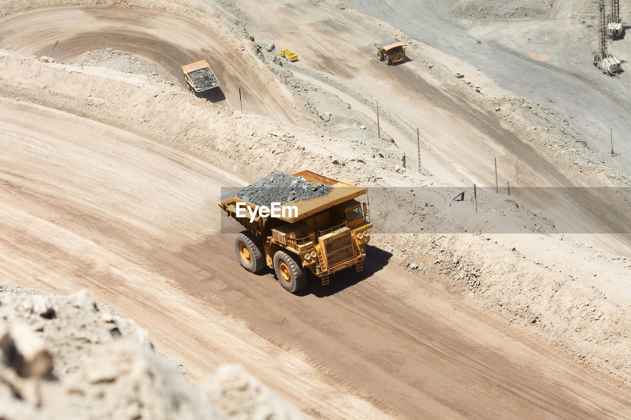 Huge dump trucks loaded with mineral in a copper mine in chile.