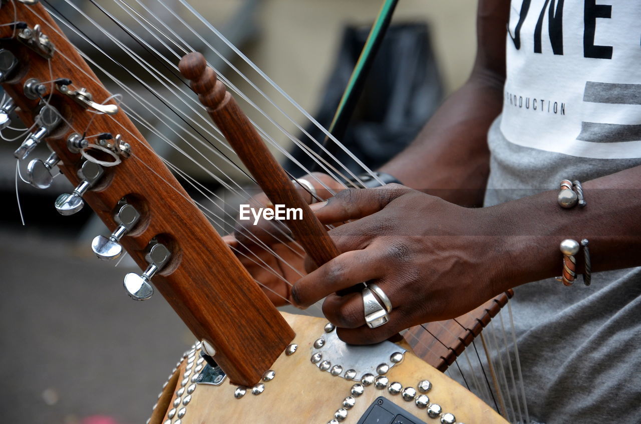 Close-up of man playing musical instrument