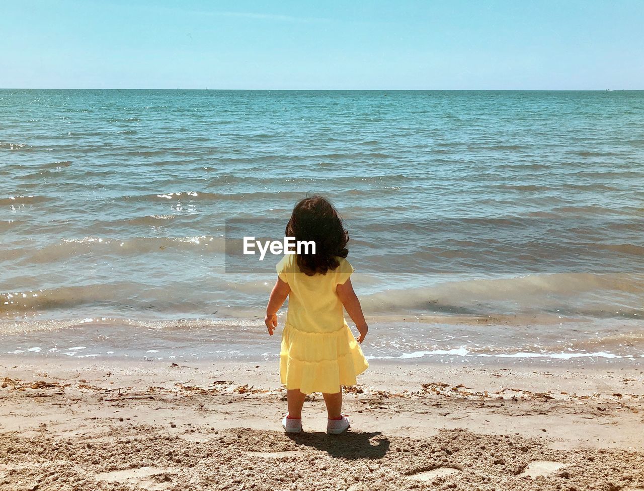 Rear view of children on beach