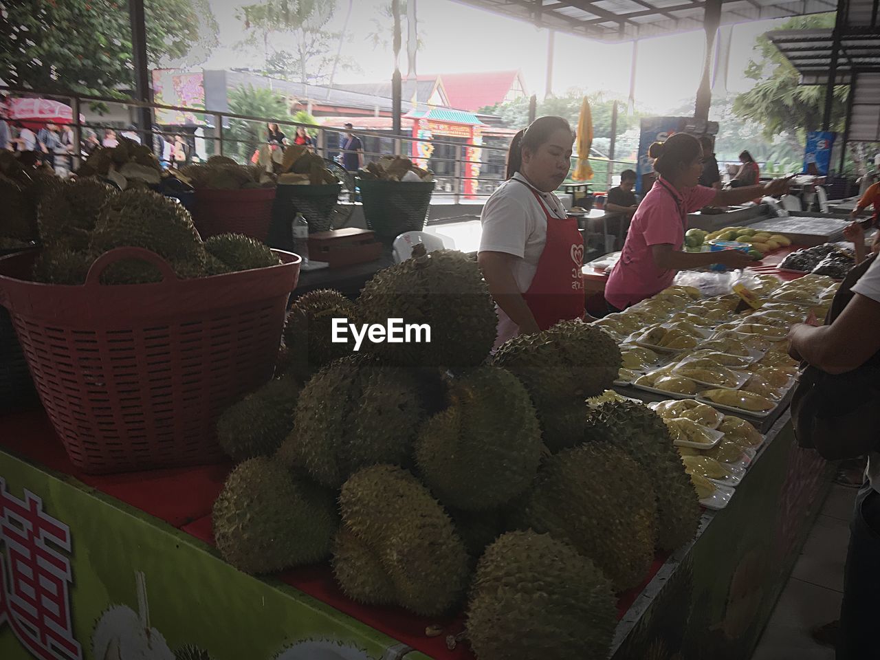 PEOPLE IN MARKET STALL