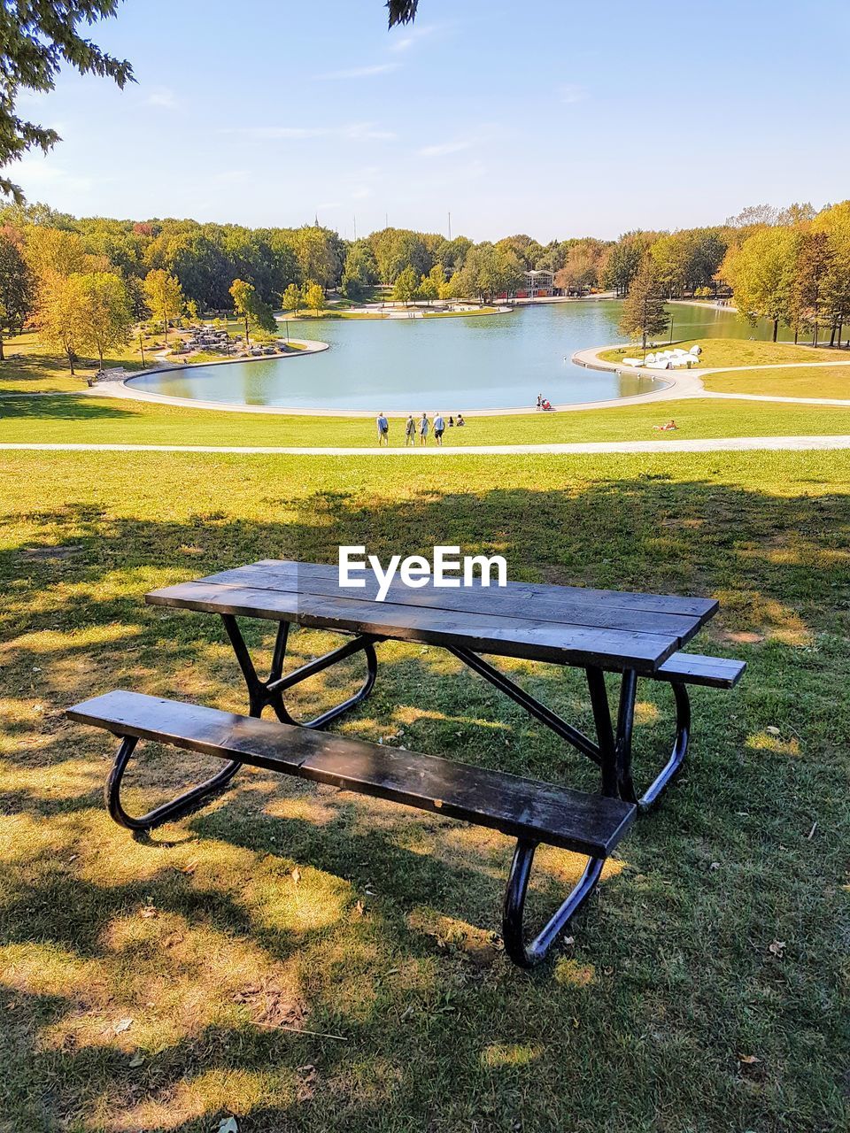 BENCH BY LAKE AGAINST SKY