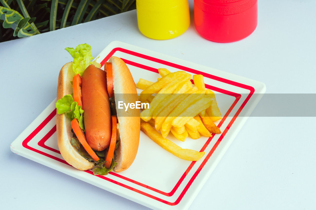food and drink, food, fast food, french fries, raw potato, unhealthy eating, dish, meal, snack, vegetable, high angle view, freshness, ketchup, drink, lunch, no people, condiment, produce, fried, table, refreshment, plate, breakfast, take out food, indoors, still life, sandwich, wellbeing, fruit, container