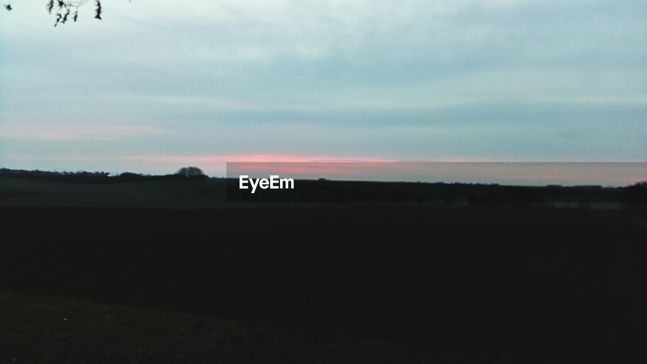 SCENIC VIEW OF LANDSCAPE AGAINST SKY DURING SUNSET