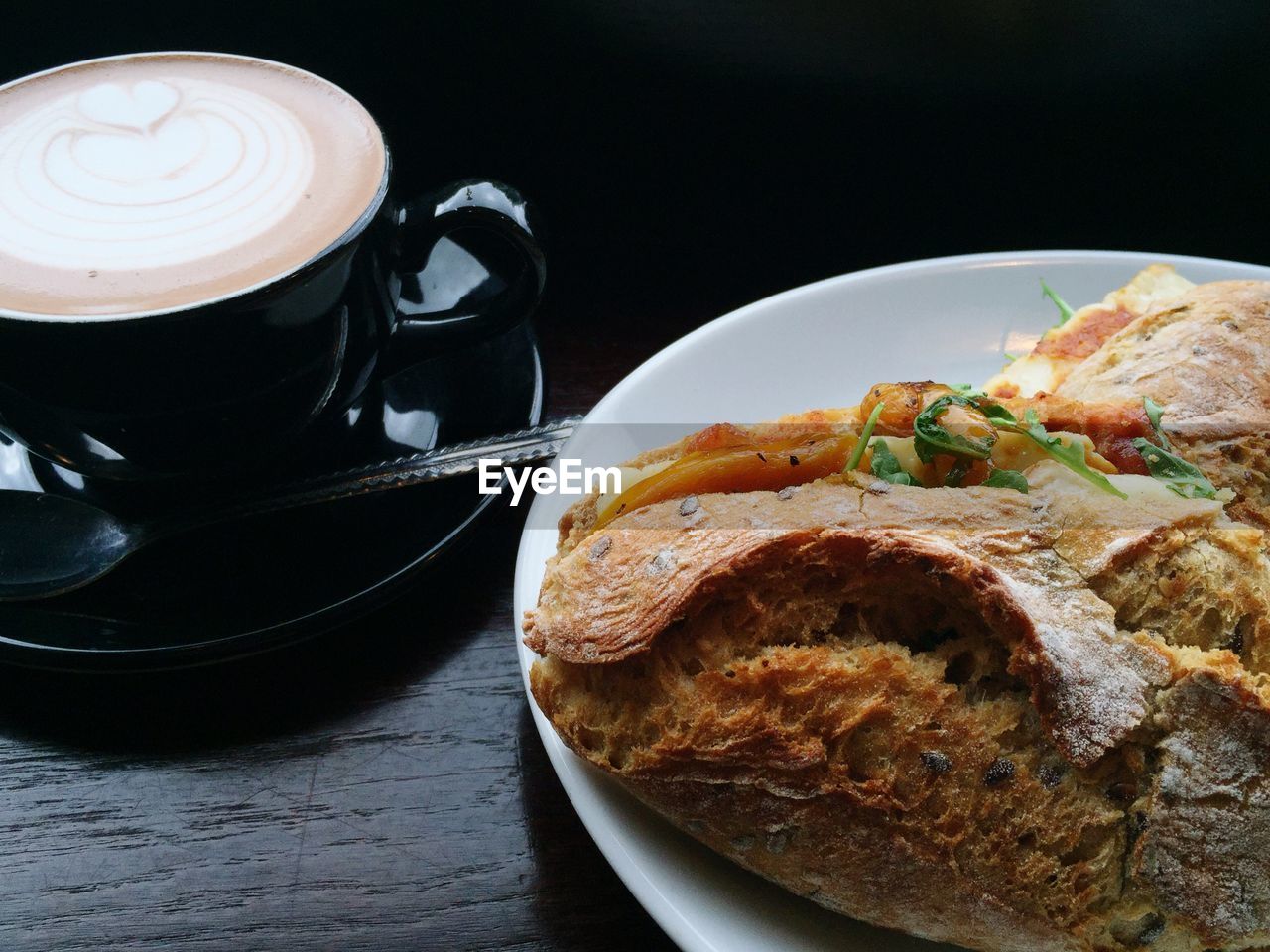 Bread served in plate by coffee cup on table