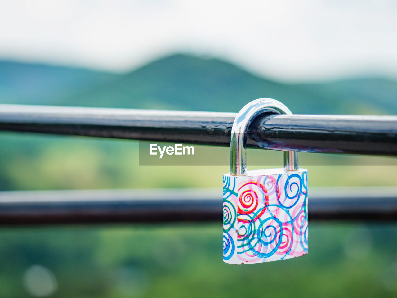 Locked red heart shaped padlock. symbol of eternal love. selective focus. the lock on handrail bar