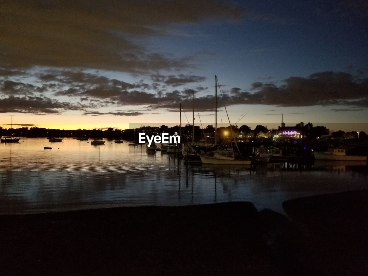 SAILBOATS IN MARINA AT SUNSET