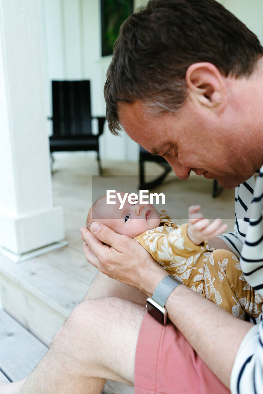 Closeup portrait of a new father holding his baby daughter