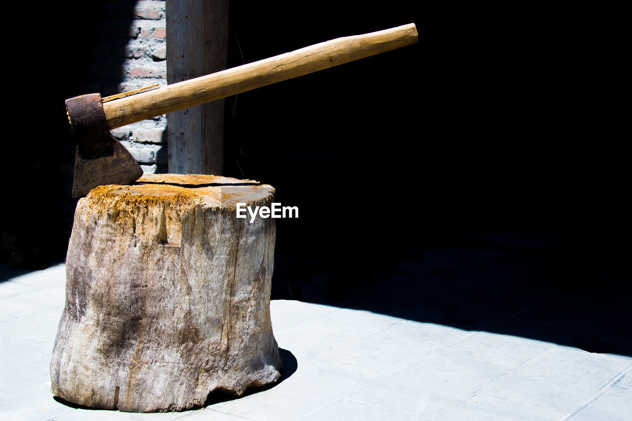 Close-up of axe in wood