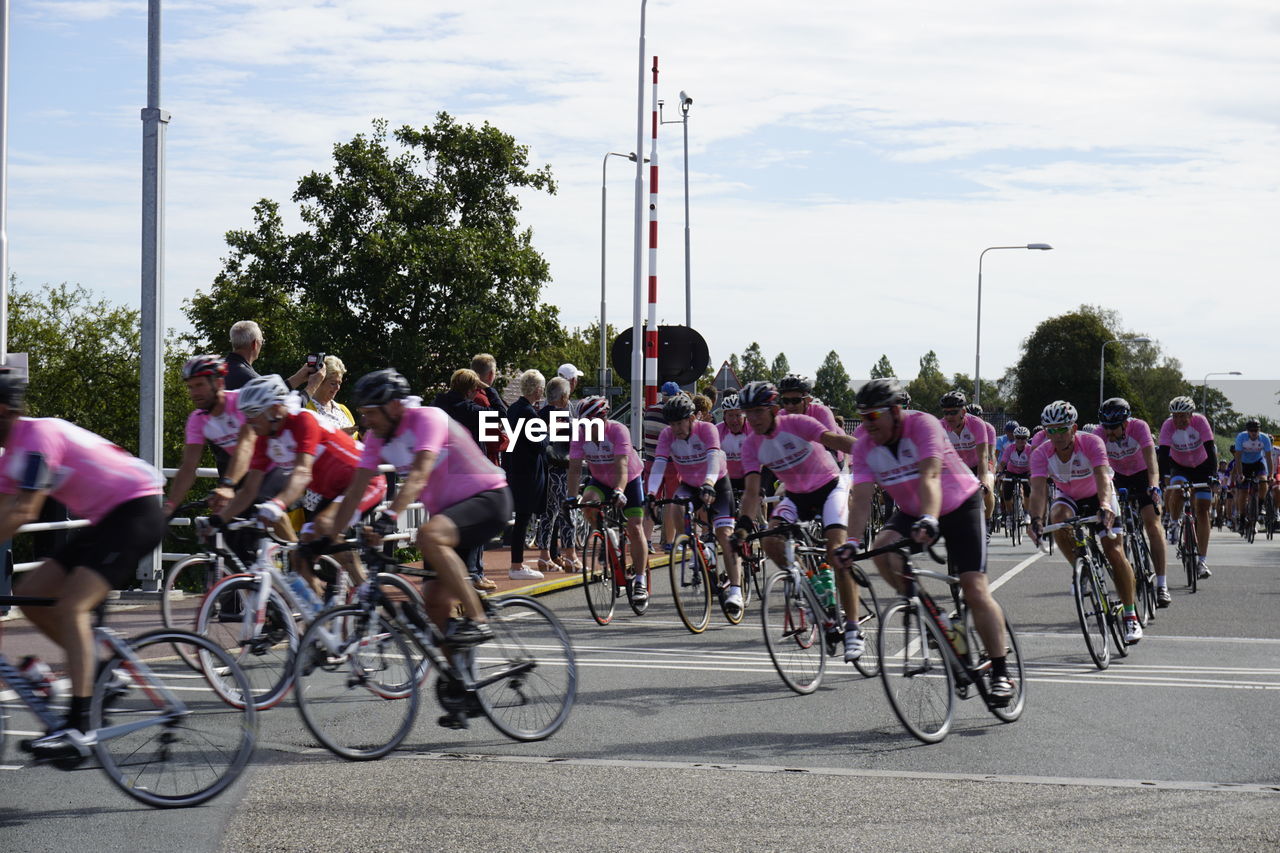 PEOPLE RIDING BICYCLE ON ROAD