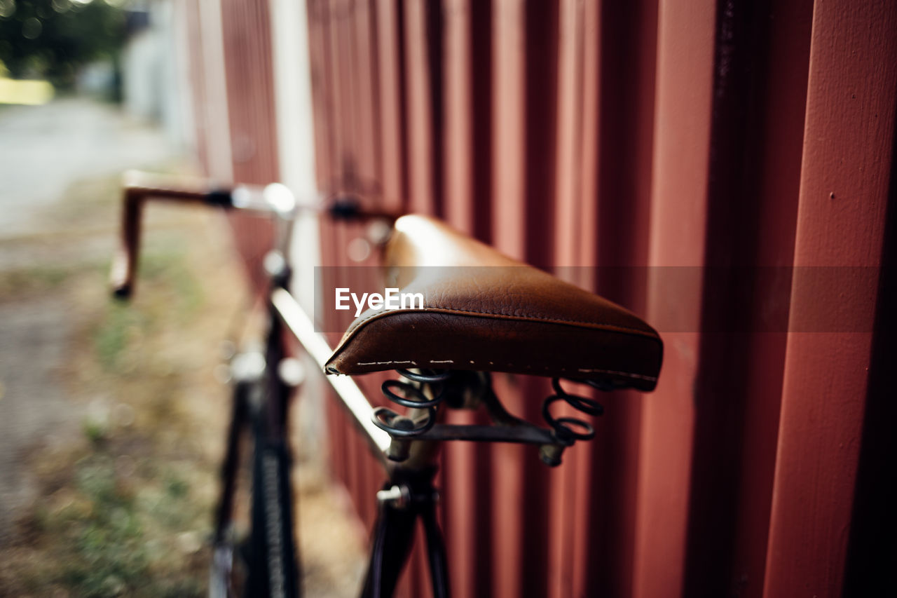 Close-up of old bicycle on wall