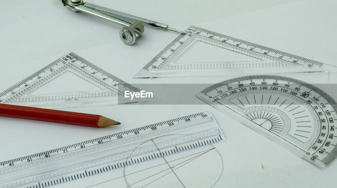 HIGH ANGLE VIEW OF PENCILS ON WHITE BACKGROUND