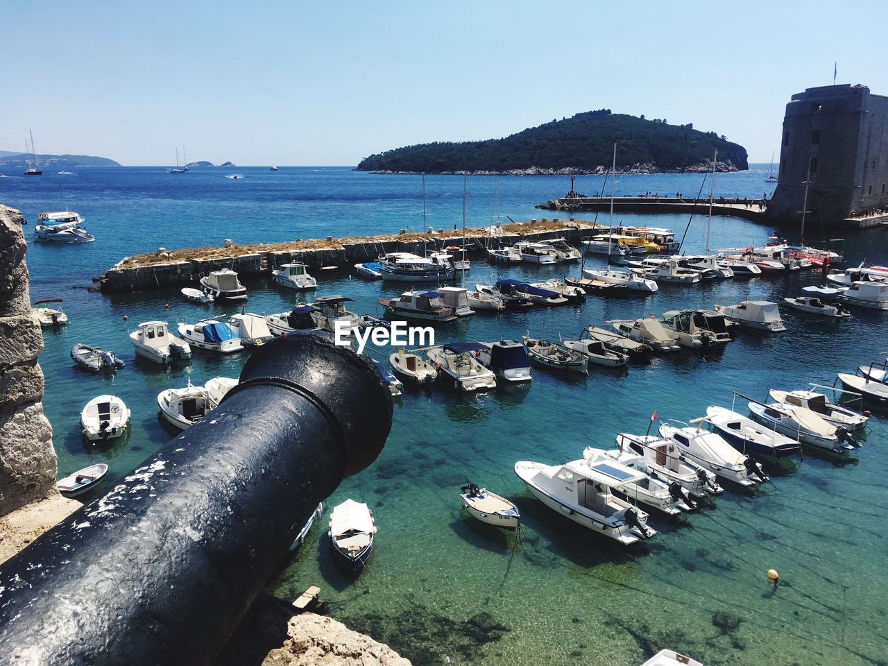 Boats moored in sea against clear sky