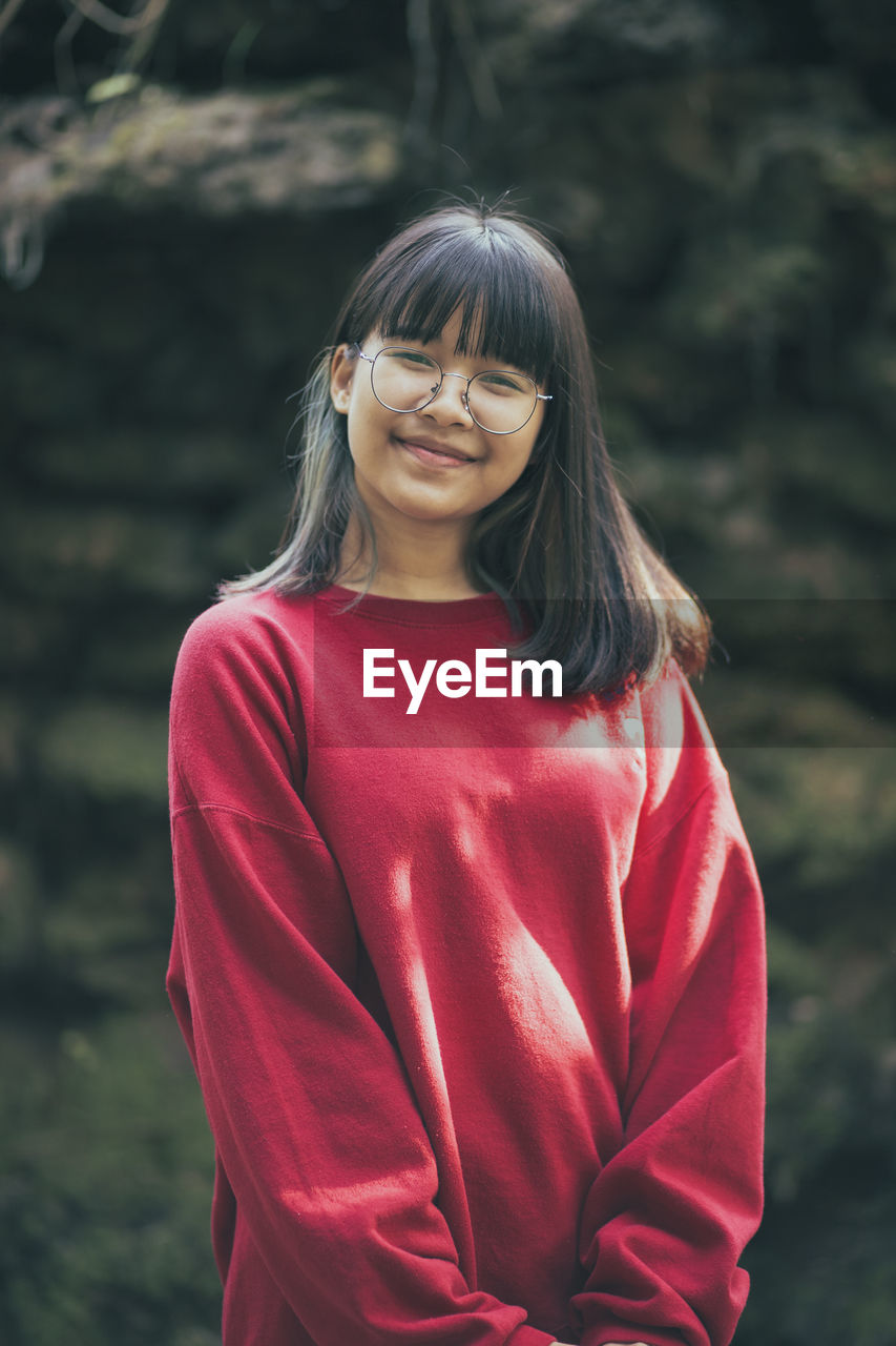 Portrait of smiling girl standing outdoors