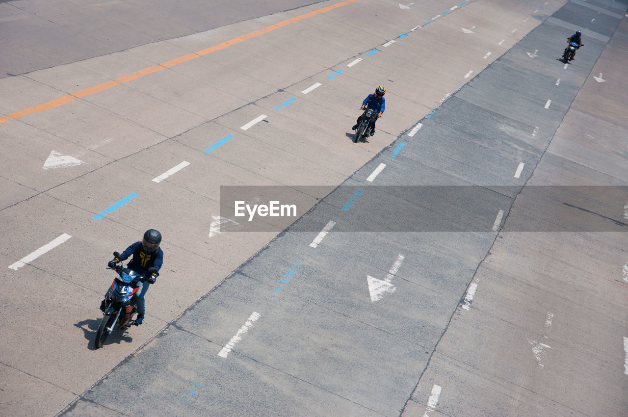 HIGH ANGLE VIEW OF PEOPLE WALKING ON STREET