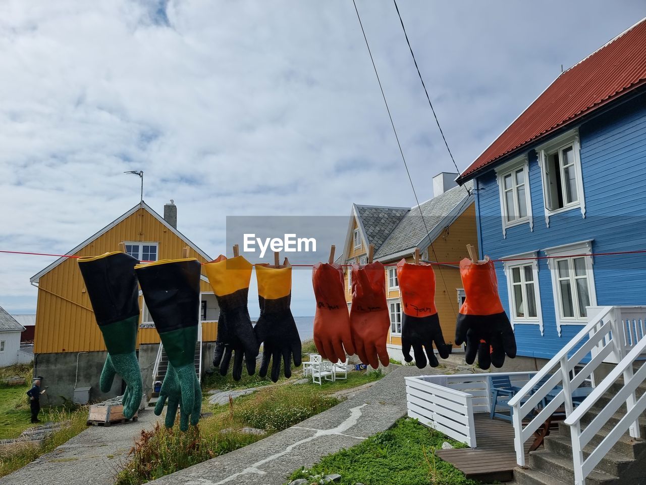 architecture, built structure, building exterior, sky, building, cloud, house, nature, town, clothesline, drying, hanging, laundry, day, clothing, in a row, residential district, outdoors, no people, city, rural area, lifestyles, vacation, wood, village, neighbourhood