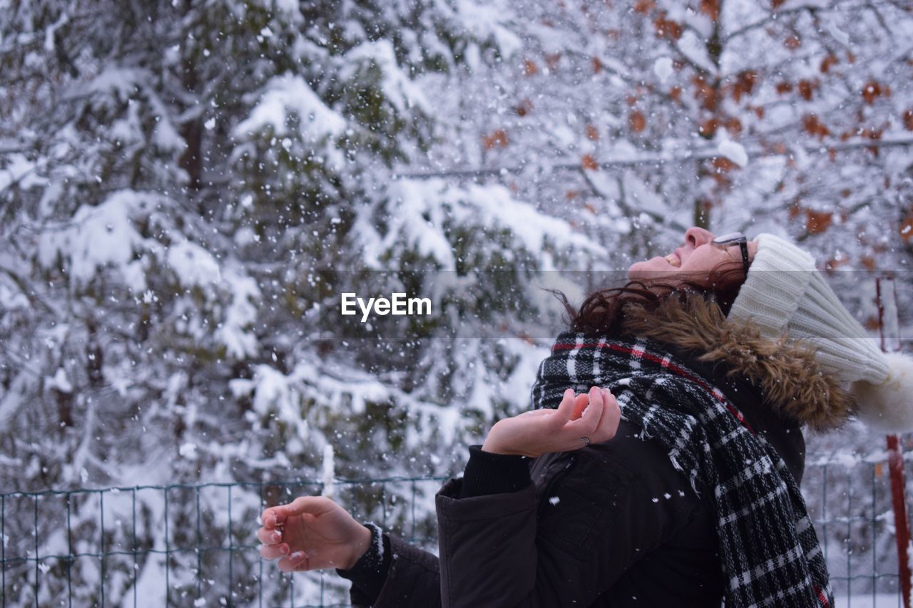 Close-up of woman standing in snow