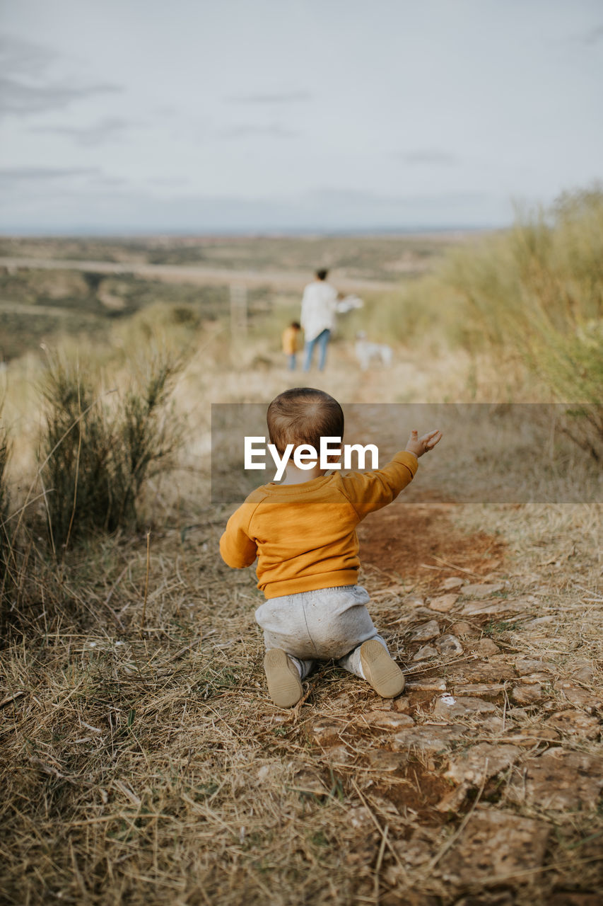 Rear view of boy on field