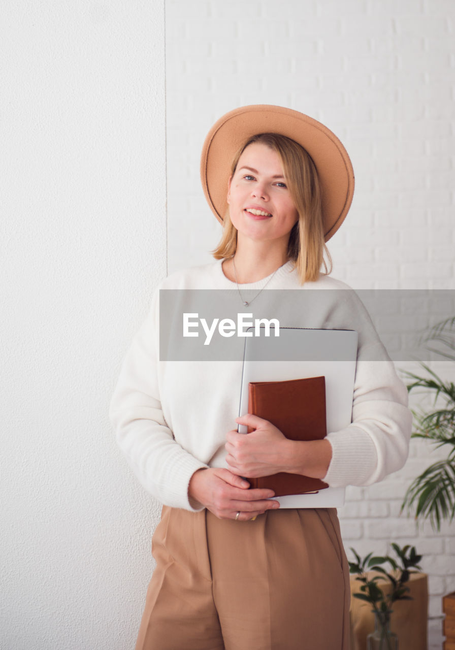 Trendy young woman in hat portrait