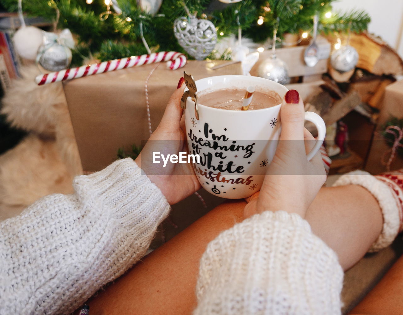 Midsection of woman holding christmas mug.