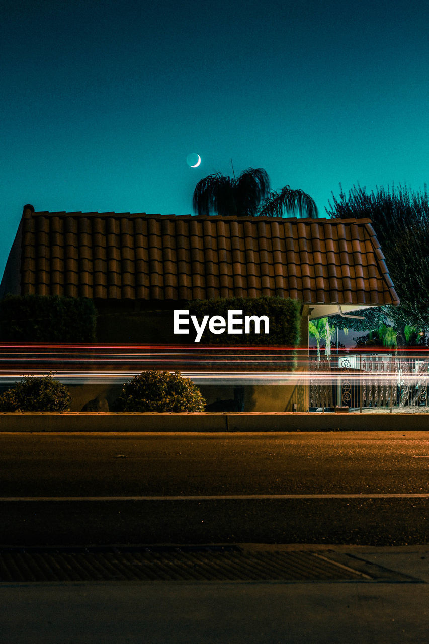 LIGHT TRAILS ON ROAD AT NIGHT