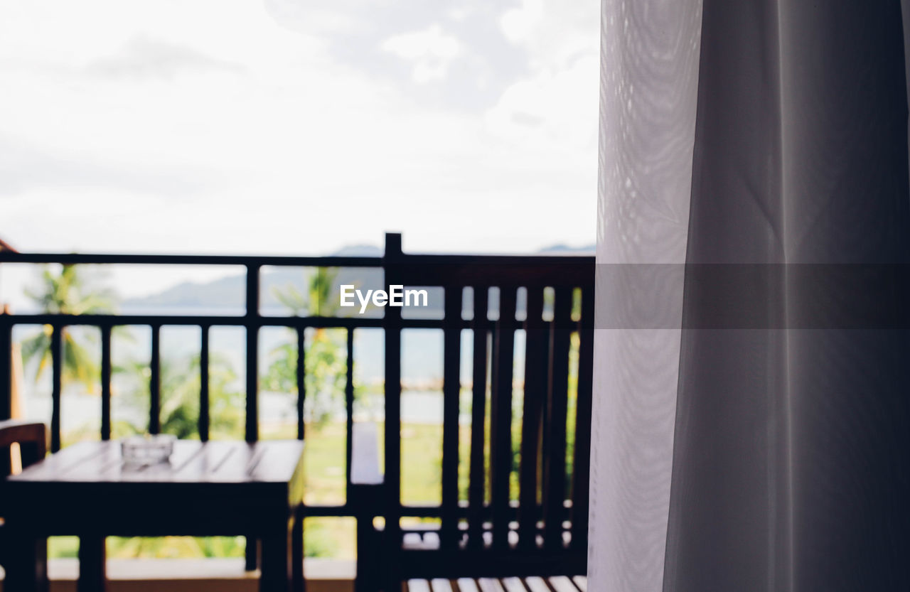 Table in balcony seen through window