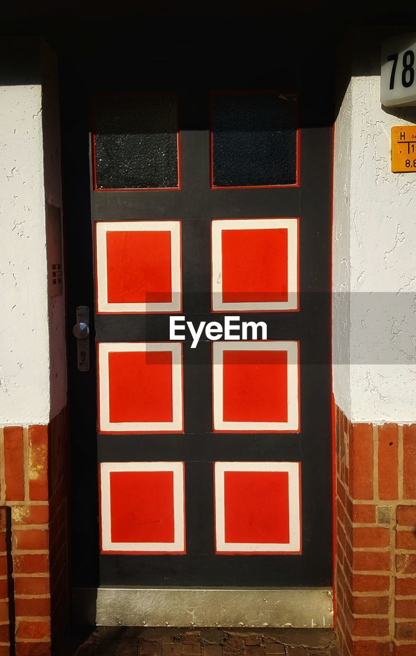 CLOSE-UP OF RED DOOR OF BUILDING