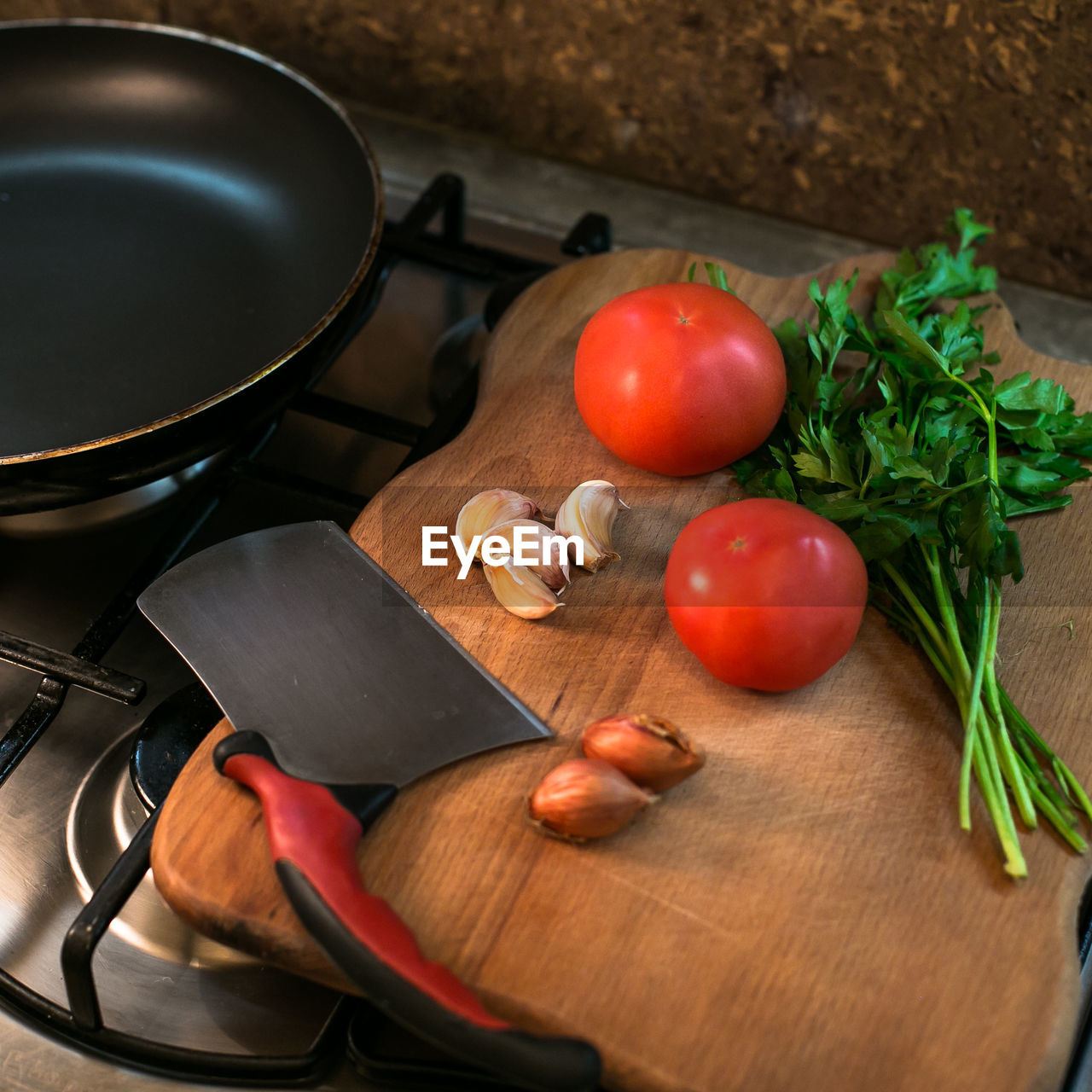 Kitchen knife and vegetables on cutting board